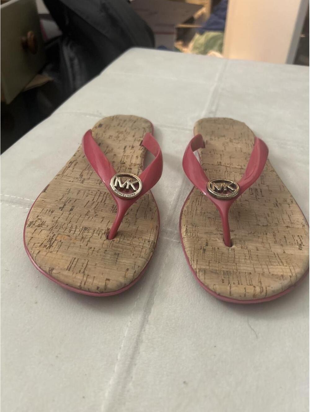 Bundle of 2 pairs of Micheal Kors Jelly flip flops size 9. One pink, one black.